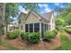 Backyard featuring a screened porch, and colorful landscaping for outdoor enjoyment at 1608 Heritage Links Dr, Wake Forest, NC 27587