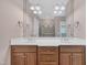 Bathroom featuring double sink vanity with wooden cabinets, white countertop, and large mirror at 1608 Heritage Links Dr, Wake Forest, NC 27587