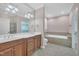 Bathroom with dual vanity, soaking tub, tiled shower, and natural light at 1608 Heritage Links Dr, Wake Forest, NC 27587