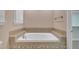 Elegant tiled bathtub with decorative trim, offering a relaxing spa-like experience at 1608 Heritage Links Dr, Wake Forest, NC 27587