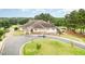Beautiful clubhouse featuring stone accents, manicured landscaping, and convenient parking for members and guests at 1608 Heritage Links Dr, Wake Forest, NC 27587