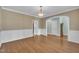 Formal dining room featuring hardwood floors, wainscoting, and an archway leading to another room at 1608 Heritage Links Dr, Wake Forest, NC 27587