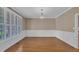 Open dining room with hardwood floors, plantation shutters, and elegant chandelier at 1608 Heritage Links Dr, Wake Forest, NC 27587