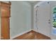 Entryway features hardwood floors, white door with sidelights, and a decorative clock at 1608 Heritage Links Dr, Wake Forest, NC 27587