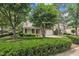 View of a beautiful home with lush landscaping, mature trees, and a well-maintained lawn at 1608 Heritage Links Dr, Wake Forest, NC 27587