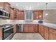 Well-lit kitchen with stainless steel appliances, tile backsplash, and wood cabinets at 1608 Heritage Links Dr, Wake Forest, NC 27587