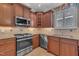 Gourmet kitchen featuring stainless steel appliances, granite countertops, and custom cabinets at 1608 Heritage Links Dr, Wake Forest, NC 27587