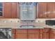Kitchen sink area featuring stainless steel fixtures, granite countertops, and tiled backsplash at 1608 Heritage Links Dr, Wake Forest, NC 27587