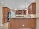 Kitchen with stainless steel appliances, wooden cabinetry, and breakfast bar at 1608 Heritage Links Dr, Wake Forest, NC 27587