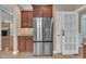 Kitchen with stainless steel refrigerator, wooden cabinets, and tile flooring at 1608 Heritage Links Dr, Wake Forest, NC 27587
