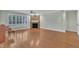 Bright living room with hardwood floors, stone fireplace, and large windows with shutters at 1608 Heritage Links Dr, Wake Forest, NC 27587