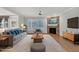 Cozy living room showcases stone fireplace, shuttered windows, and comfortable furnishings at 1608 Heritage Links Dr, Wake Forest, NC 27587