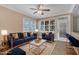 Staged living room features neutral paint, tiled flooring, and comfortable furniture at 1608 Heritage Links Dr, Wake Forest, NC 27587
