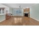 Sun-filled living room featuring a stone fireplace, hardwood floors, and large shuttered windows at 1608 Heritage Links Dr, Wake Forest, NC 27587