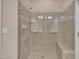 Tile shower with glass door and bench, providing a luxurious and accessible showering experience at 1608 Heritage Links Dr, Wake Forest, NC 27587