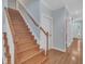 Staircase with wooden steps, white risers, and hardwood floors leading to the upper level at 1608 Heritage Links Dr, Wake Forest, NC 27587