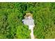 Aerial view of a home nestled among lush, mature trees and a private driveway at 166 Daffodil Ln, Clayton, NC 27527