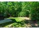 A well-manicured backyard featuring lush green grass and mature trees, creating a private outdoor space at 166 Daffodil Ln, Clayton, NC 27527