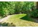 Beautifully landscaped backyard, offering a serene retreat surrounded by lush greenery and mature trees at 166 Daffodil Ln, Clayton, NC 27527