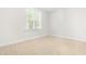 Bright bedroom featuring a large window letting in natural light and neutral carpet at 166 Daffodil Ln, Clayton, NC 27527