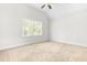 Bright bedroom with neutral tones and a large window, providing ample natural light and a cozy atmosphere at 166 Daffodil Ln, Clayton, NC 27527