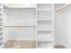 Organized walk-in closet with built-in shelving and rods, providing ample storage space for clothing and accessories at 166 Daffodil Ln, Clayton, NC 27527