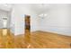 Elegant dining room featuring hardwood floors, wainscoting, and a chandelier at 166 Daffodil Ln, Clayton, NC 27527