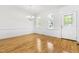 Open dining area features hardwood floors, wainscoting, natural light and a classic chandelier at 166 Daffodil Ln, Clayton, NC 27527