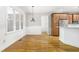 Bright dining area with white walls, hardwood flooring, and wood cabinets nearby at 166 Daffodil Ln, Clayton, NC 27527