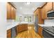 Modern kitchen with stainless steel appliances, white countertops, and custom wood cabinets at 166 Daffodil Ln, Clayton, NC 27527