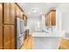 Updated kitchen with wood cabinets, a stainless steel refrigerator, and a breakfast bar at 166 Daffodil Ln, Clayton, NC 27527