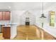 Bright and open living room connected to the kitchen with a fireplace and outdoor access at 166 Daffodil Ln, Clayton, NC 27527
