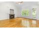 Spacious living room featuring a cozy fireplace and large windows for abundant natural light at 166 Daffodil Ln, Clayton, NC 27527