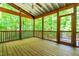 Charming screened porch with wood flooring and a view of the surrounding trees at 166 Daffodil Ln, Clayton, NC 27527