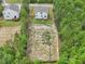 An aerial view of the home showcasing the large fenced backyard surrounded by mature trees for privacy at 170 Baker Farm Dr, Youngsville, NC 27596