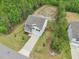 An aerial view of the property showing the well-manicured front yard and large fenced in backyard with tree line at 170 Baker Farm Dr, Youngsville, NC 27596