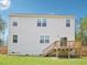 A view of the rear of the home featuring the second story windows and the wooden deck with stairs to the yard at 170 Baker Farm Dr, Youngsville, NC 27596