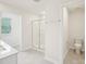 Bright bathroom featuring a walk-in shower and a toilet at 170 Baker Farm Dr, Youngsville, NC 27596