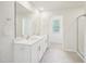 Bright bathroom featuring double sinks and a large mirror at 170 Baker Farm Dr, Youngsville, NC 27596