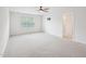 A spacious bedroom with neutral carpet, a ceiling fan, and a large window at 170 Baker Farm Dr, Youngsville, NC 27596