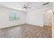 Large bedroom with wood-style flooring, a ceiling fan, and plenty of natural light at 170 Baker Farm Dr, Youngsville, NC 27596
