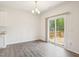 Bright dining area with wood-style flooring and sliding door to a private deck at 170 Baker Farm Dr, Youngsville, NC 27596