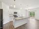 Modern kitchen features white cabinets, granite countertops, stainless appliances, and a center island at 170 Baker Farm Dr, Youngsville, NC 27596