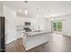 Modern kitchen features white cabinets, granite countertops, stainless appliances, and a large center island at 170 Baker Farm Dr, Youngsville, NC 27596