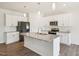 Modern kitchen featuring white cabinets, granite countertops, stainless appliances, and a center island at 170 Baker Farm Dr, Youngsville, NC 27596