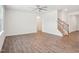 Spacious living room with wood-style flooring and stairs leading to upper level at 170 Baker Farm Dr, Youngsville, NC 27596