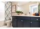 Modern bathroom with a blue vanity, a bathtub/shower with a curtain, and a framed picture at 18 Relaxing Way, Pittsboro, NC 27312