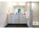 Modern bathroom featuring double vanity, stone countertops, and a glass-enclosed shower at 18 Relaxing Way, Pittsboro, NC 27312