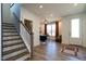 Bright, inviting foyer with hardwood floors, staircase, and stylish entryway to the living area at 18 Relaxing Way, Pittsboro, NC 27312