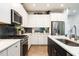 Modern kitchen featuring stainless steel appliances, white cabinetry, and a stylish herringbone tile backsplash at 18 Relaxing Way, Pittsboro, NC 27312